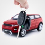 Hand holding keys to new car. Buy or selling business composition